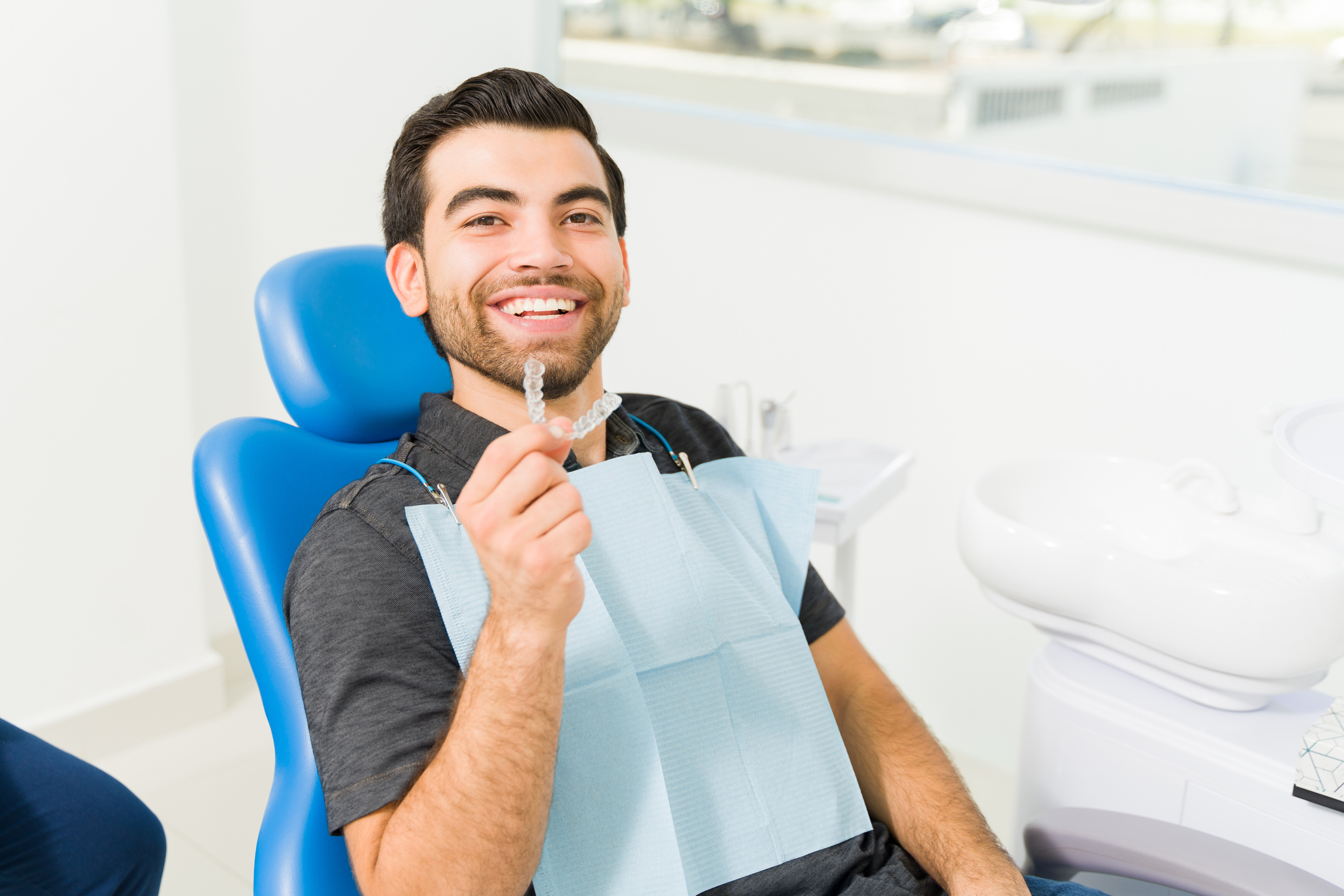 Close up of a happy man using invisible orthodontics