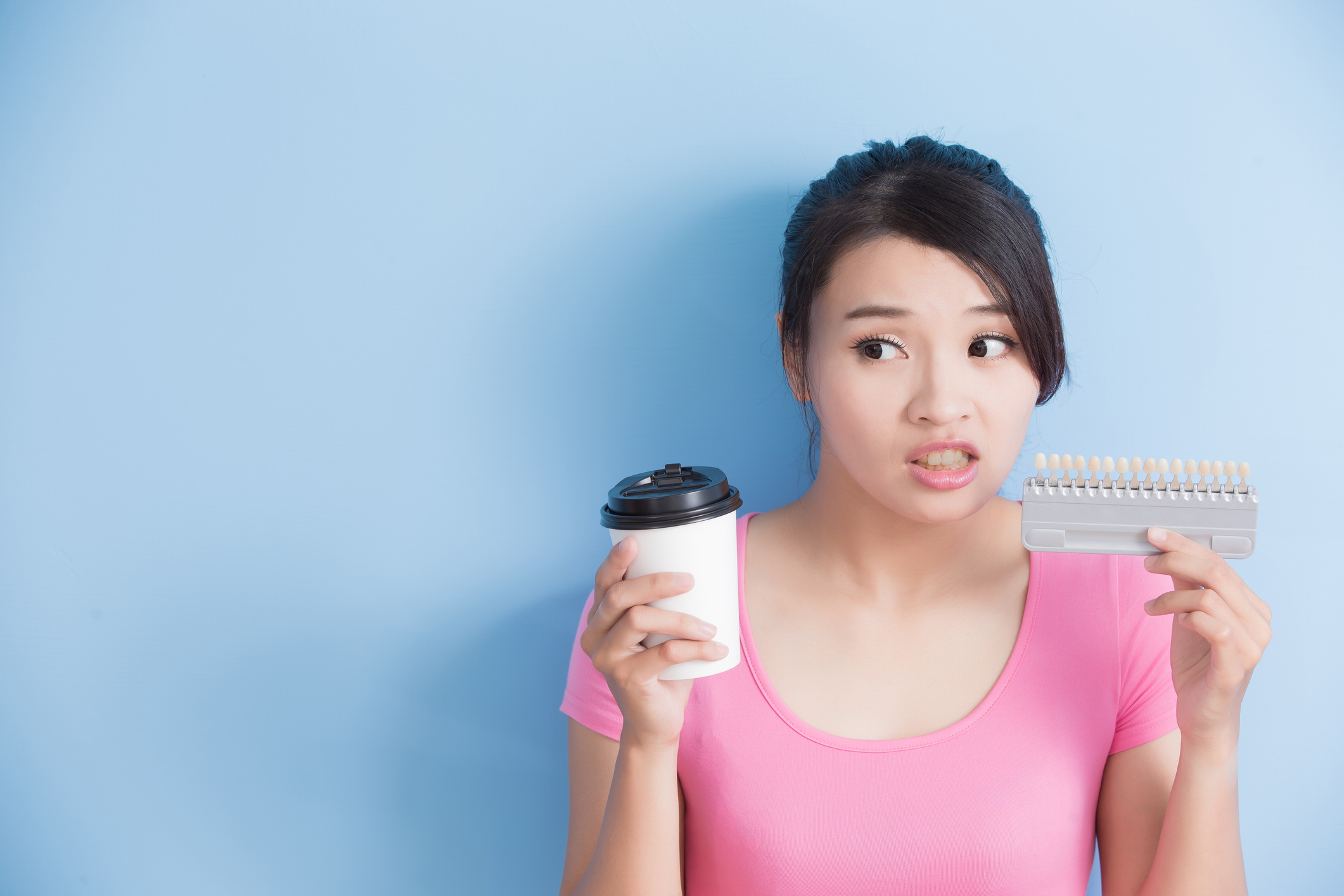 girl checking her teeth whitener